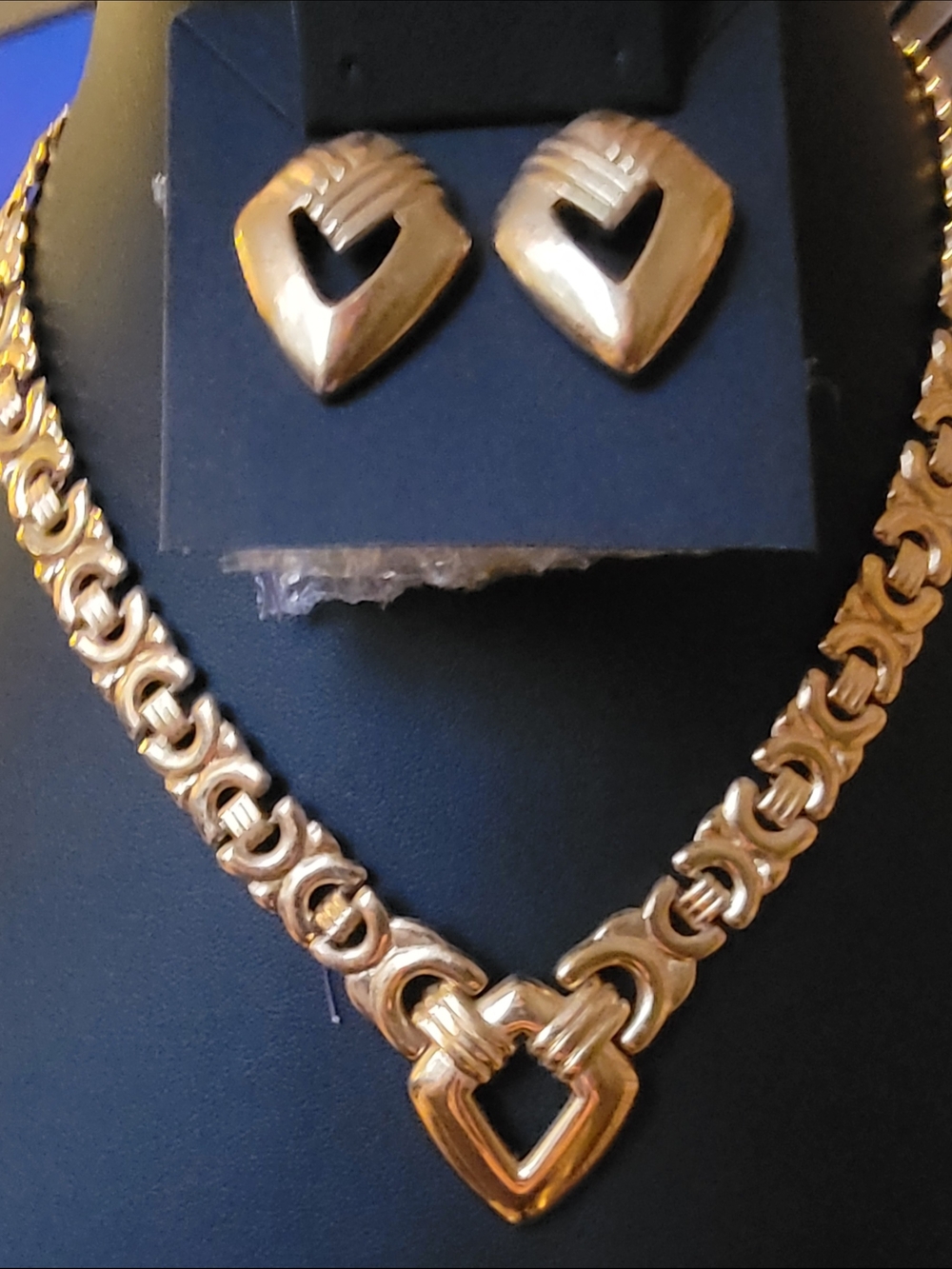 Vintage Signed Trifari jewelry set includes a gold-tone necklace and earrings